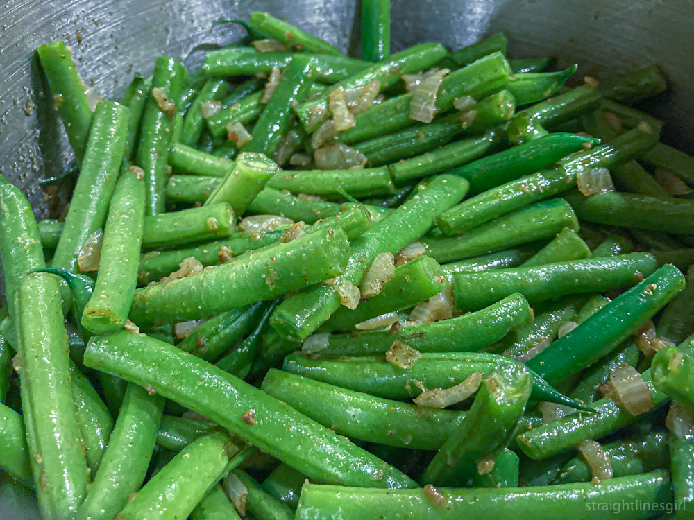 Green beans cooking with onion and garlic