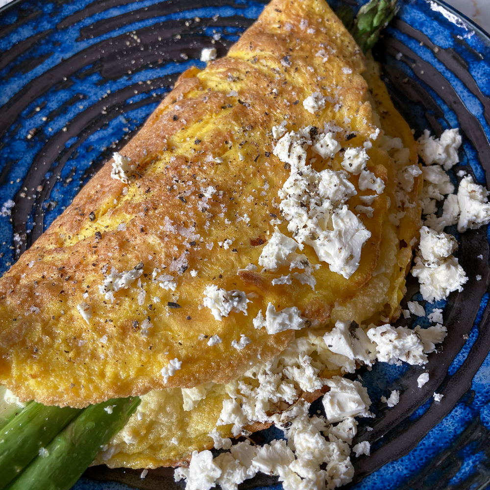 Asparagus and feta omelette on a blue plate