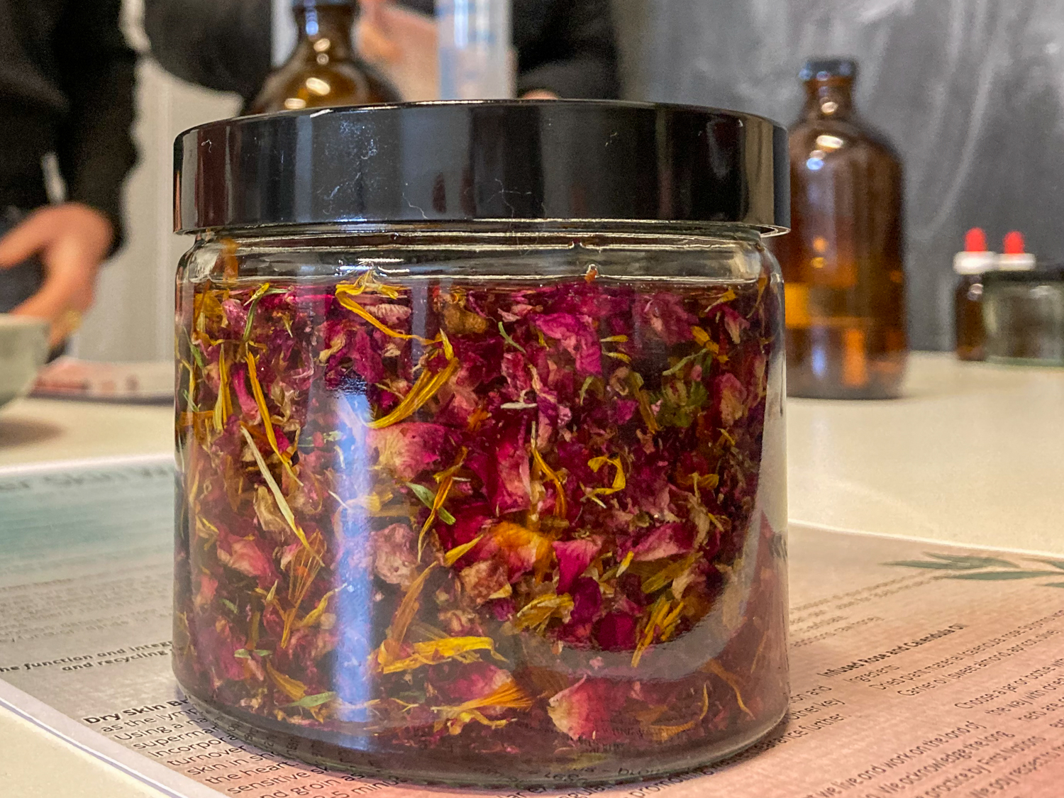 A jar of rose and calendula petals soaking in oil