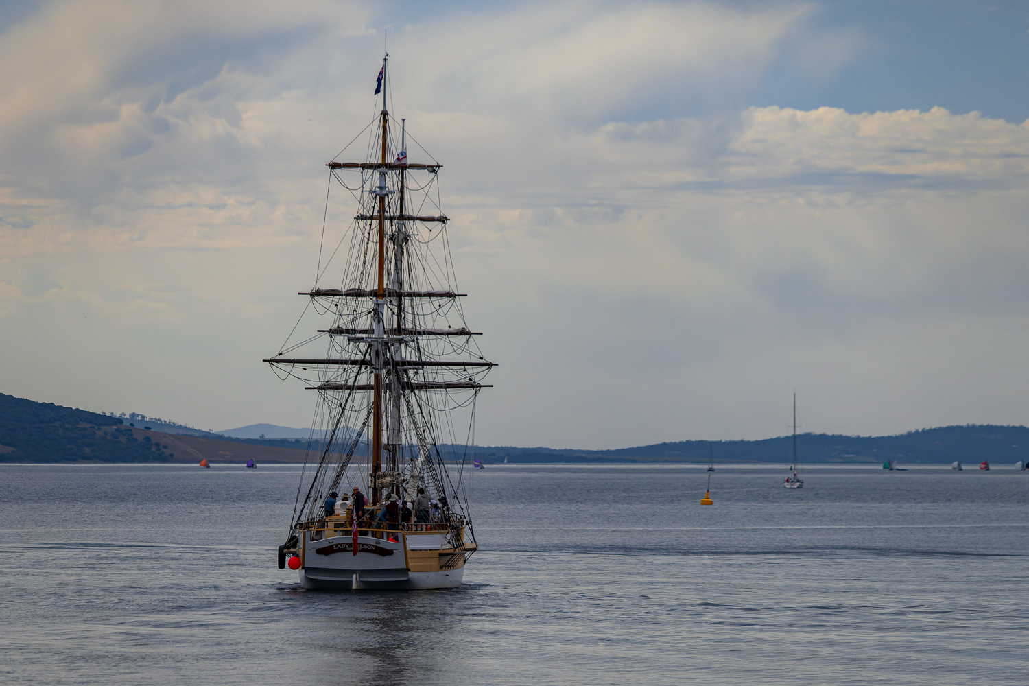 A tall ship, the Lady Nelson, sailing down the river
