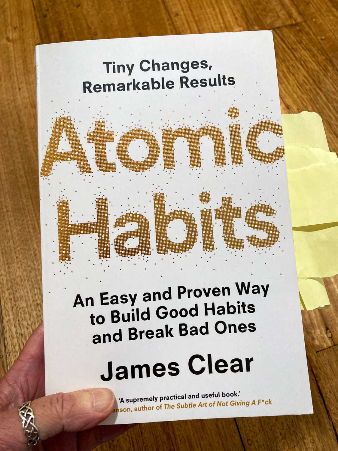 The cover of the book Atomic Habits: Tiny Changes, Remarkable Results. An easy and proven way to build good habits and break bad ones.