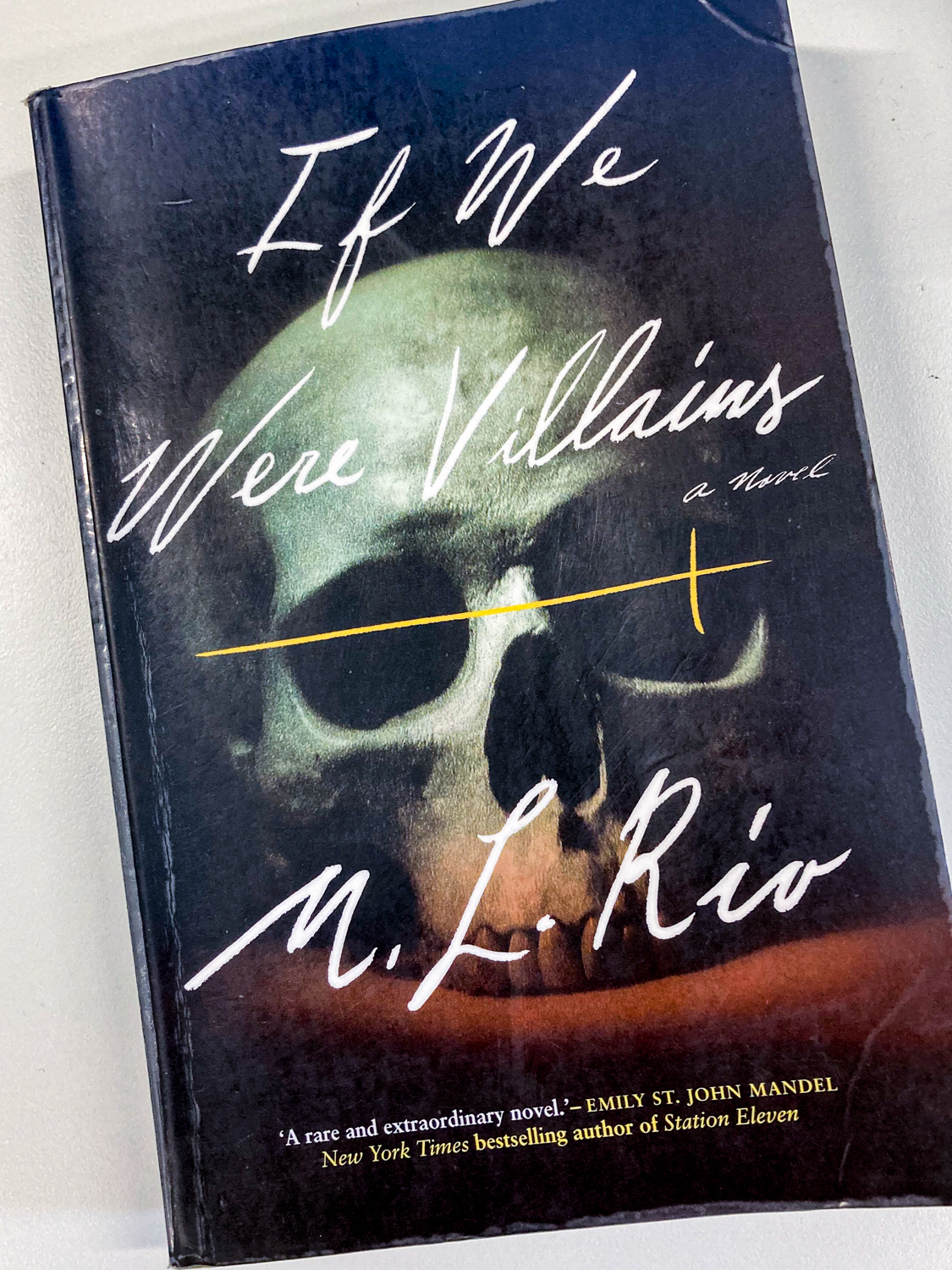 A book cover photo of a skull with the title If We Were Villains M.L. Rio