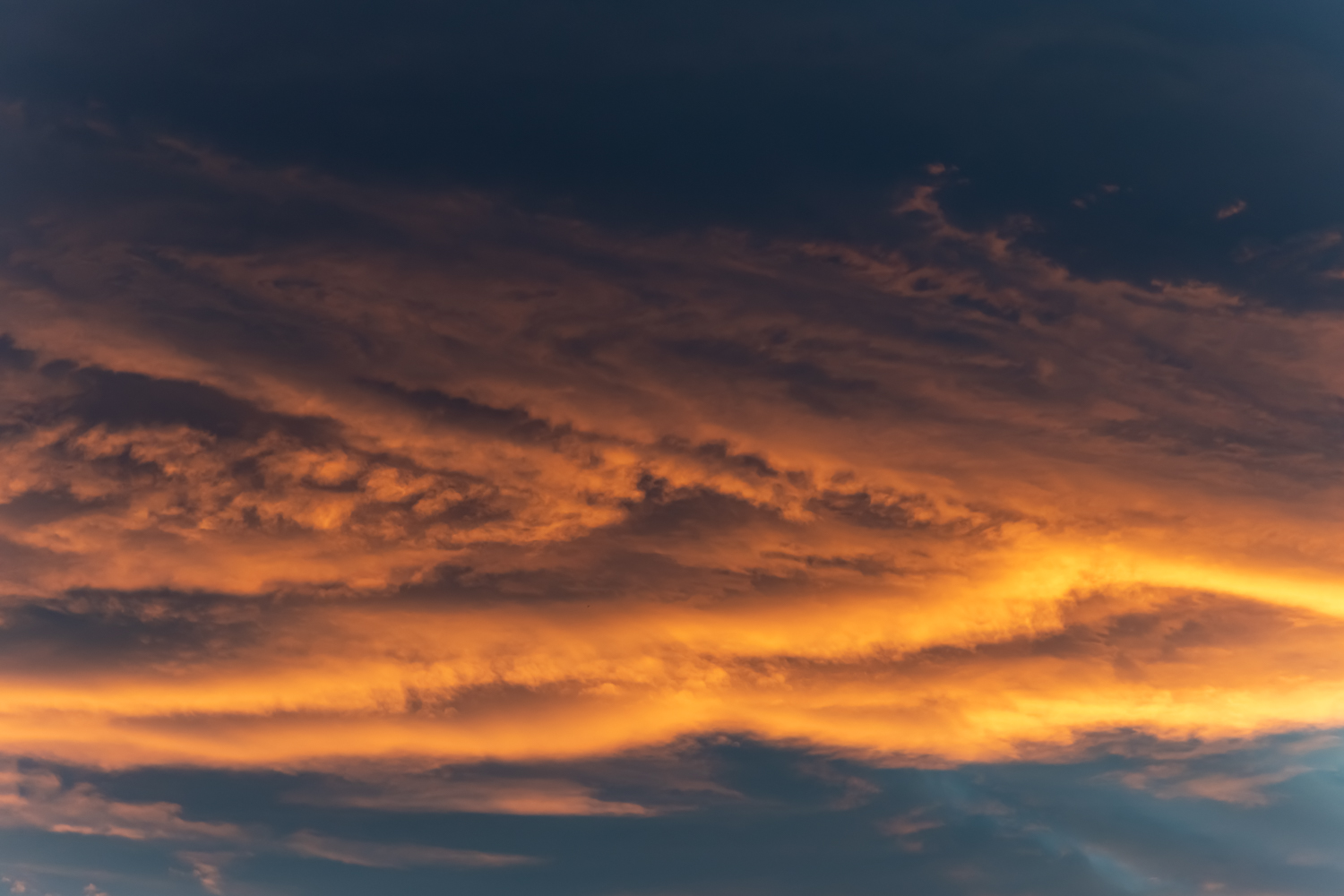 Deep orange and yellow clouds in a sunset sky