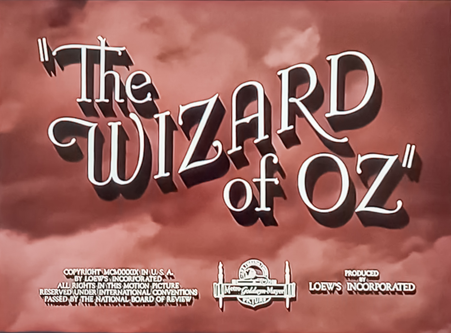 An old style toned photo of clouds with the text The Wizard of Oz in large capital letters