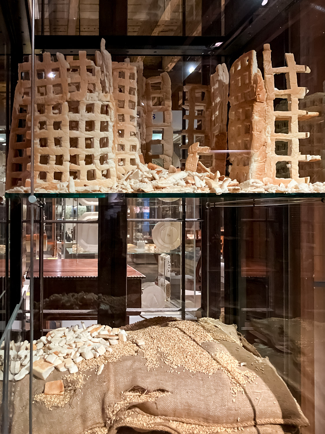 Half-destroyed buildings made from bread, atop a grain sack