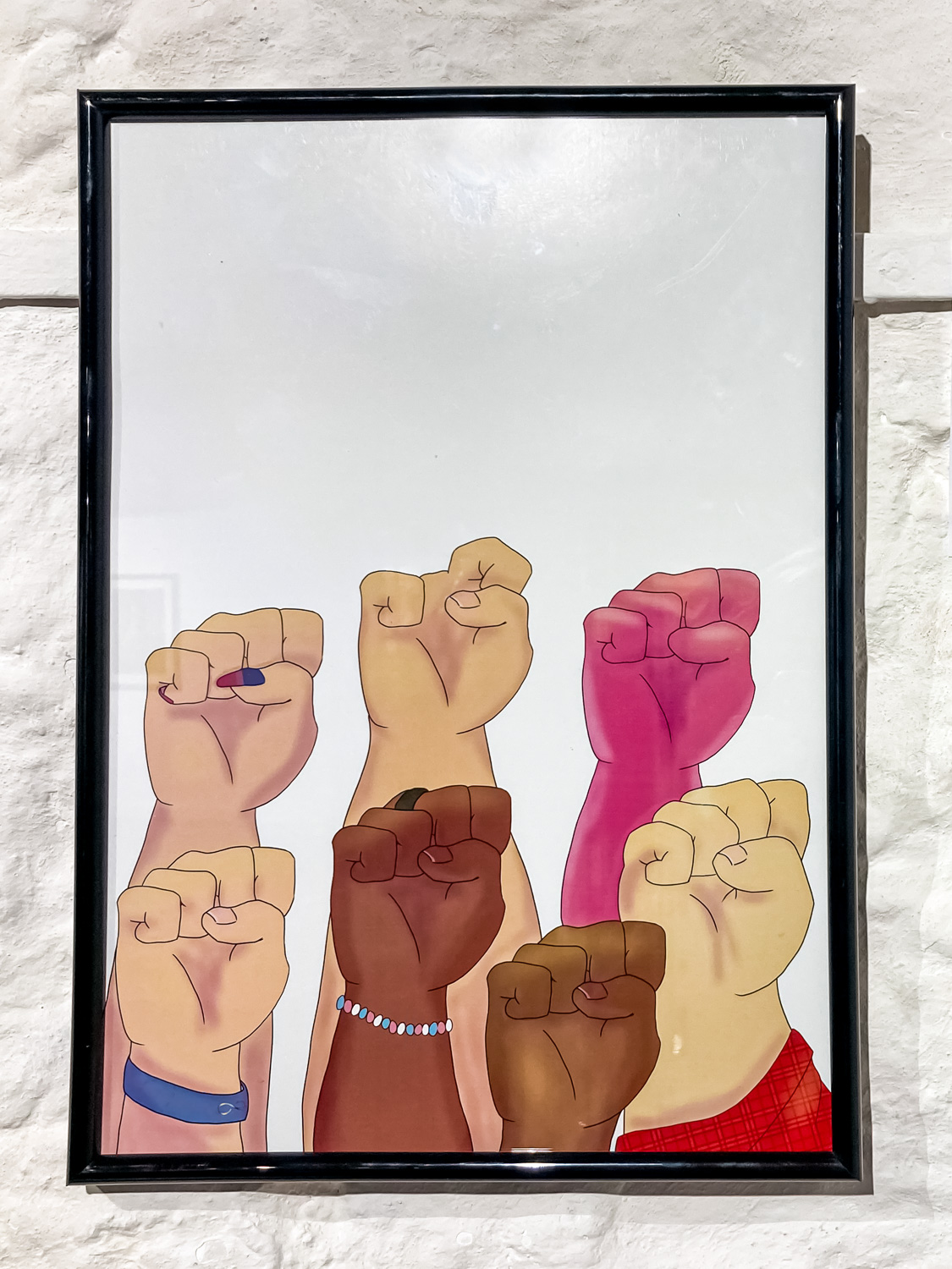 An art work of seven raised fists of various skin colours