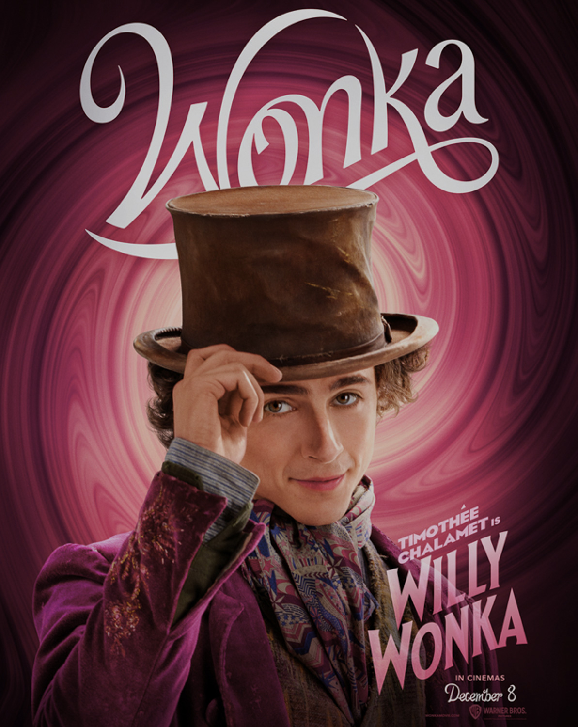 A dark-haired young man in a top hat and suit coat in front of a maroon swirling background with the word Wonka predominantly displayed