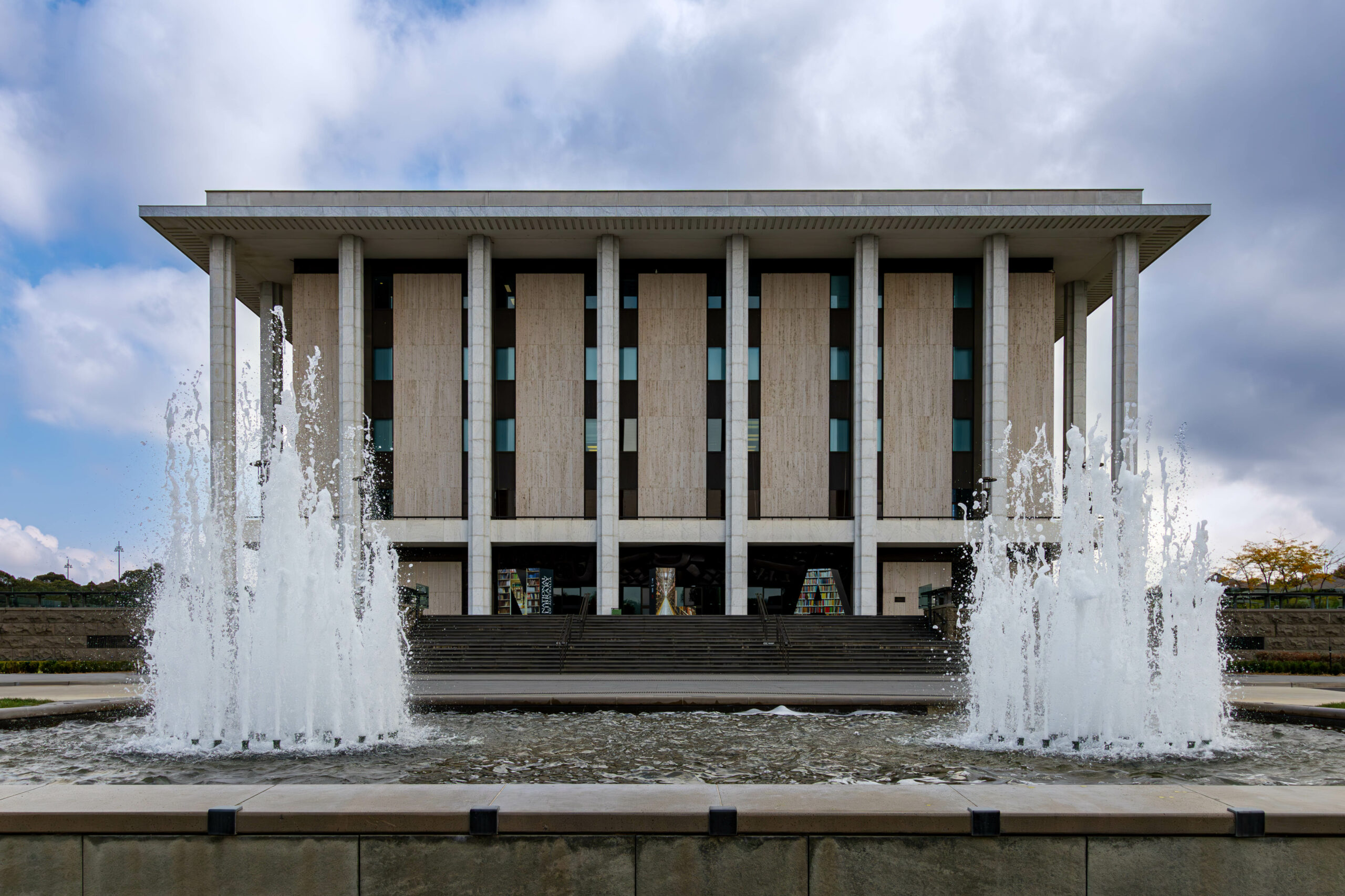 A modernist building of eight columns, based on a classical design, with two water fountains at the front