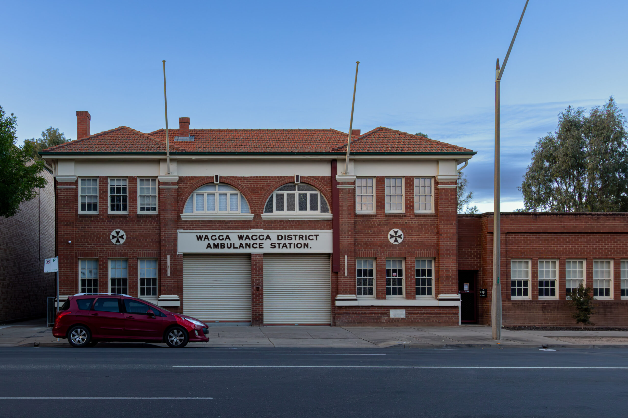 a 1920s red brick two-storey building with a red tile roof called Wagga Wagga District Ambulance Station