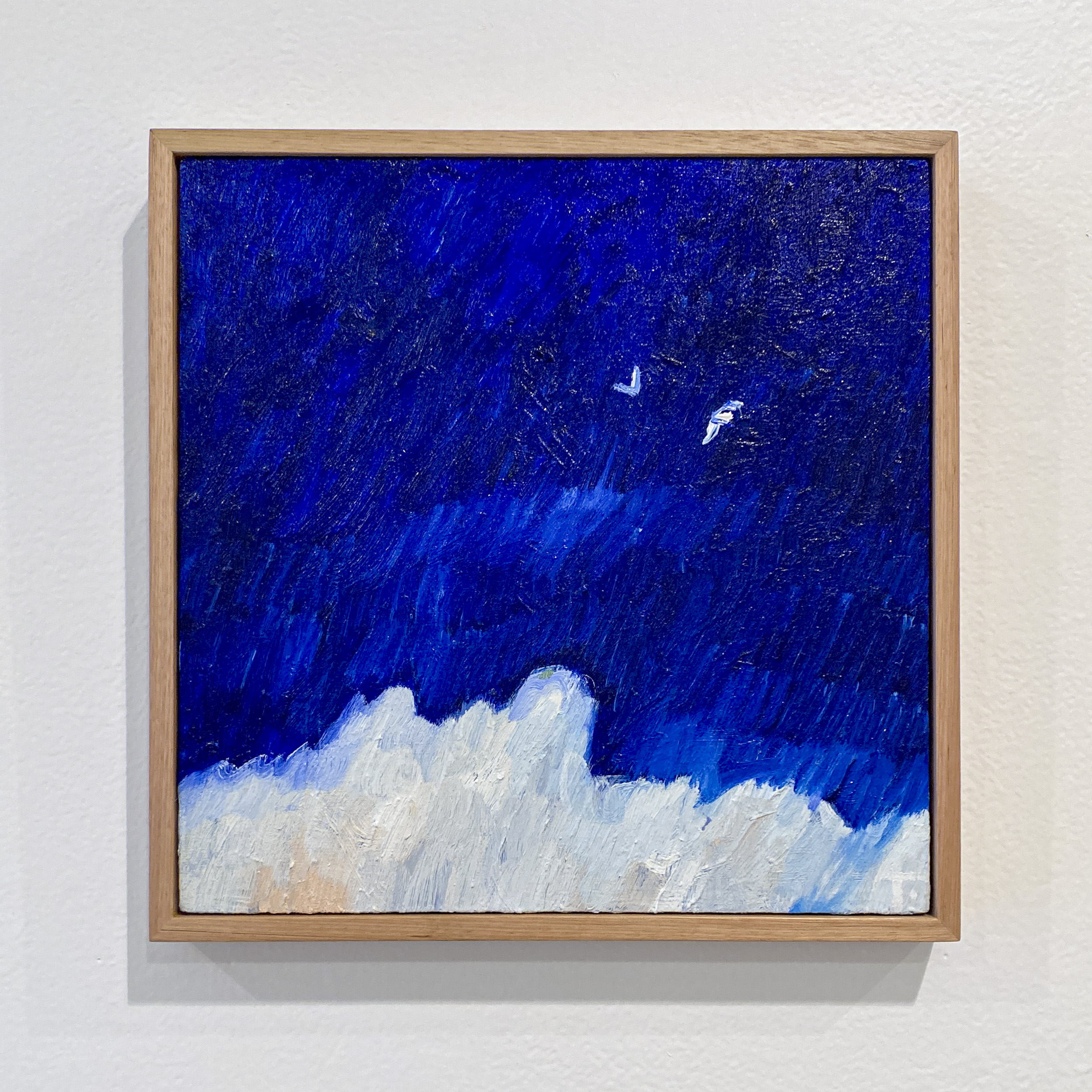 A square oil painting with bright blue sky and two small white birds flying above what might be white clouds below