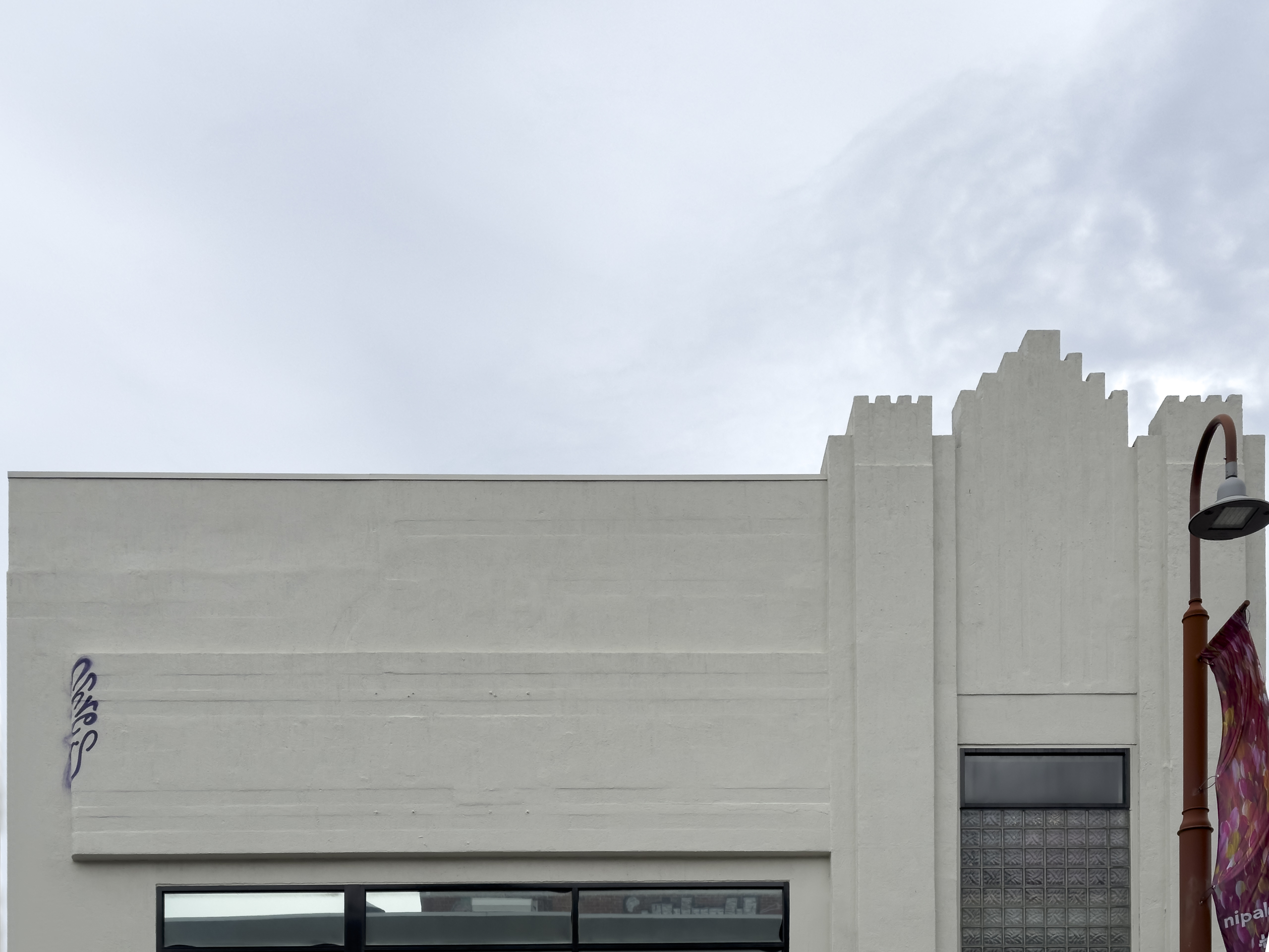 the very top of a white art deco building with distinctive stepping features