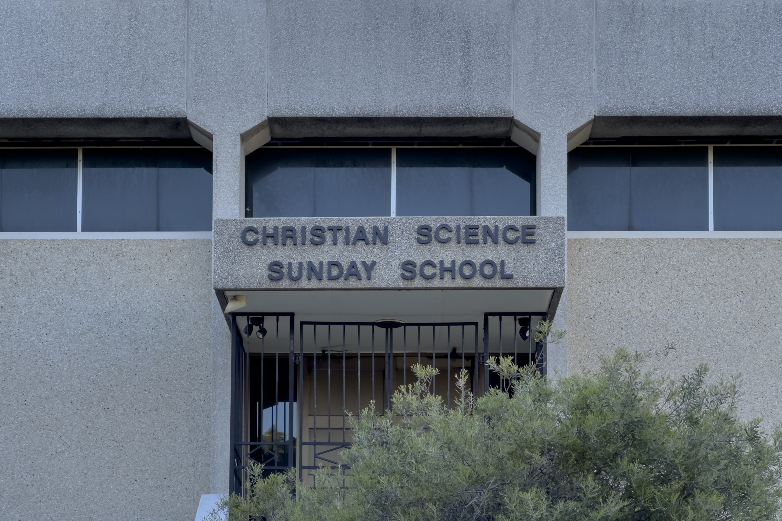 Close up image of a concrete building with the words "Christian Science Sunday School" over the entance