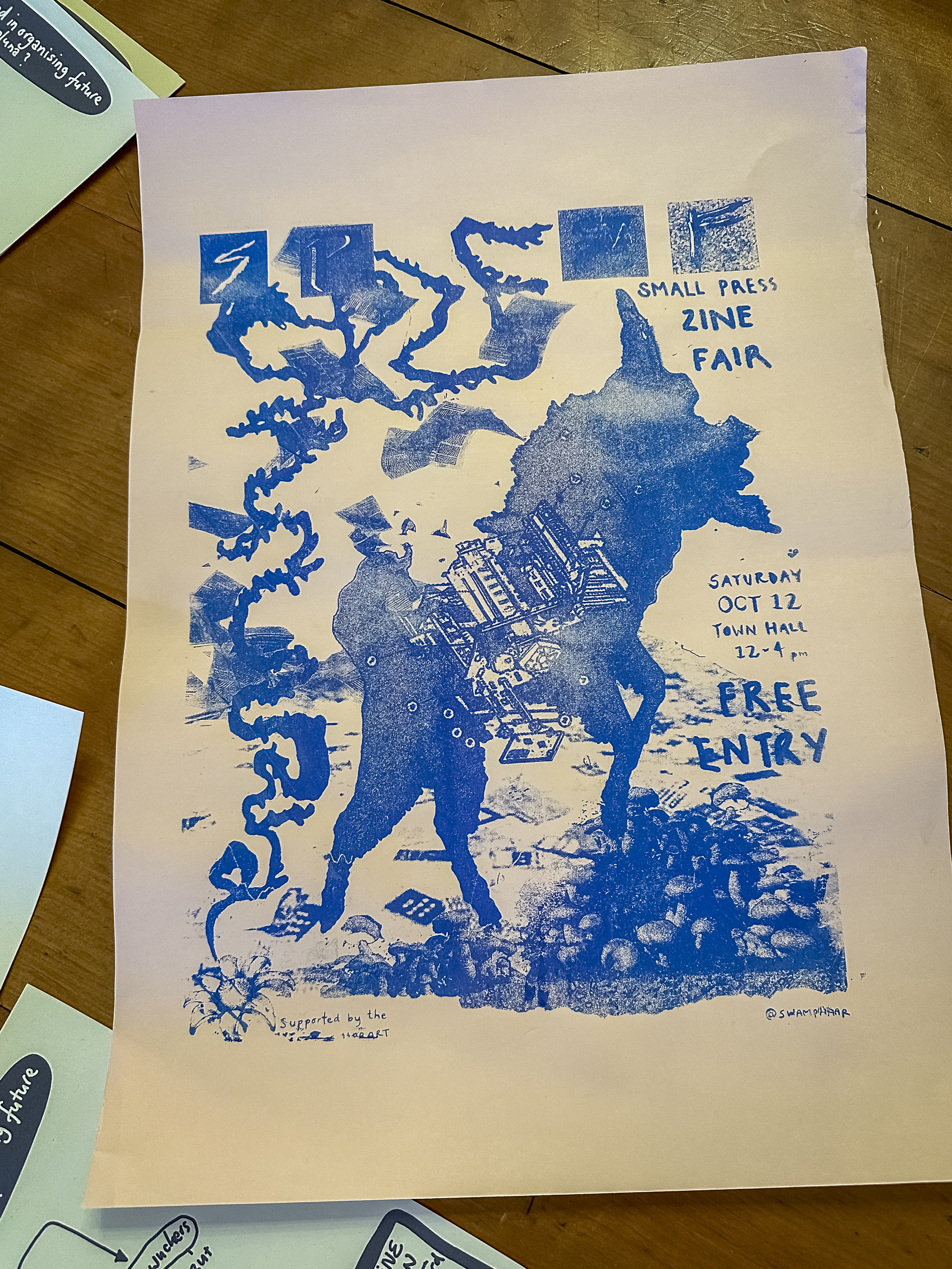 A blue hand printed poster advertising the Small Press Zine Fair in Hobart