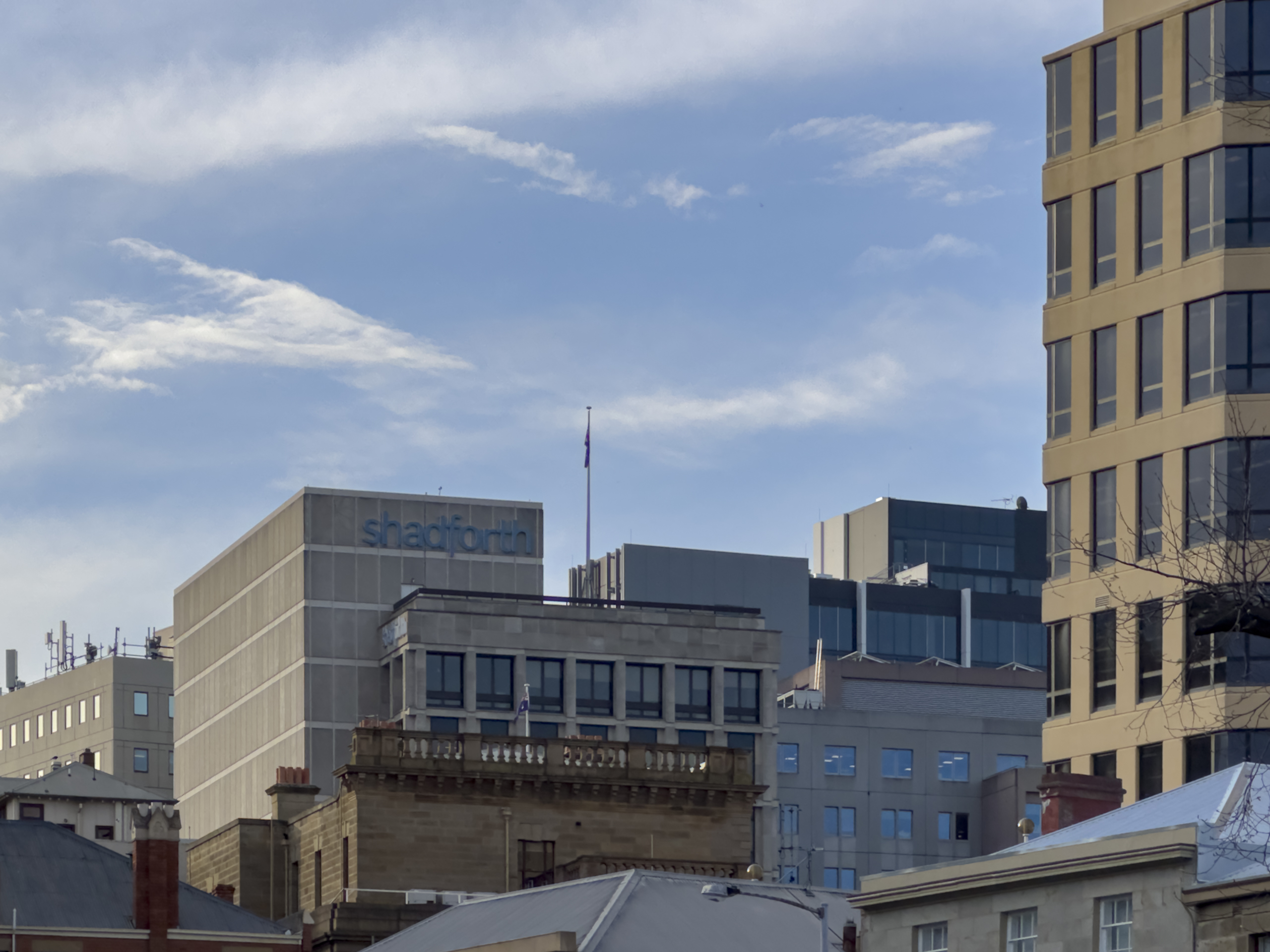 A zoomed in view of the tops of some tall buildings