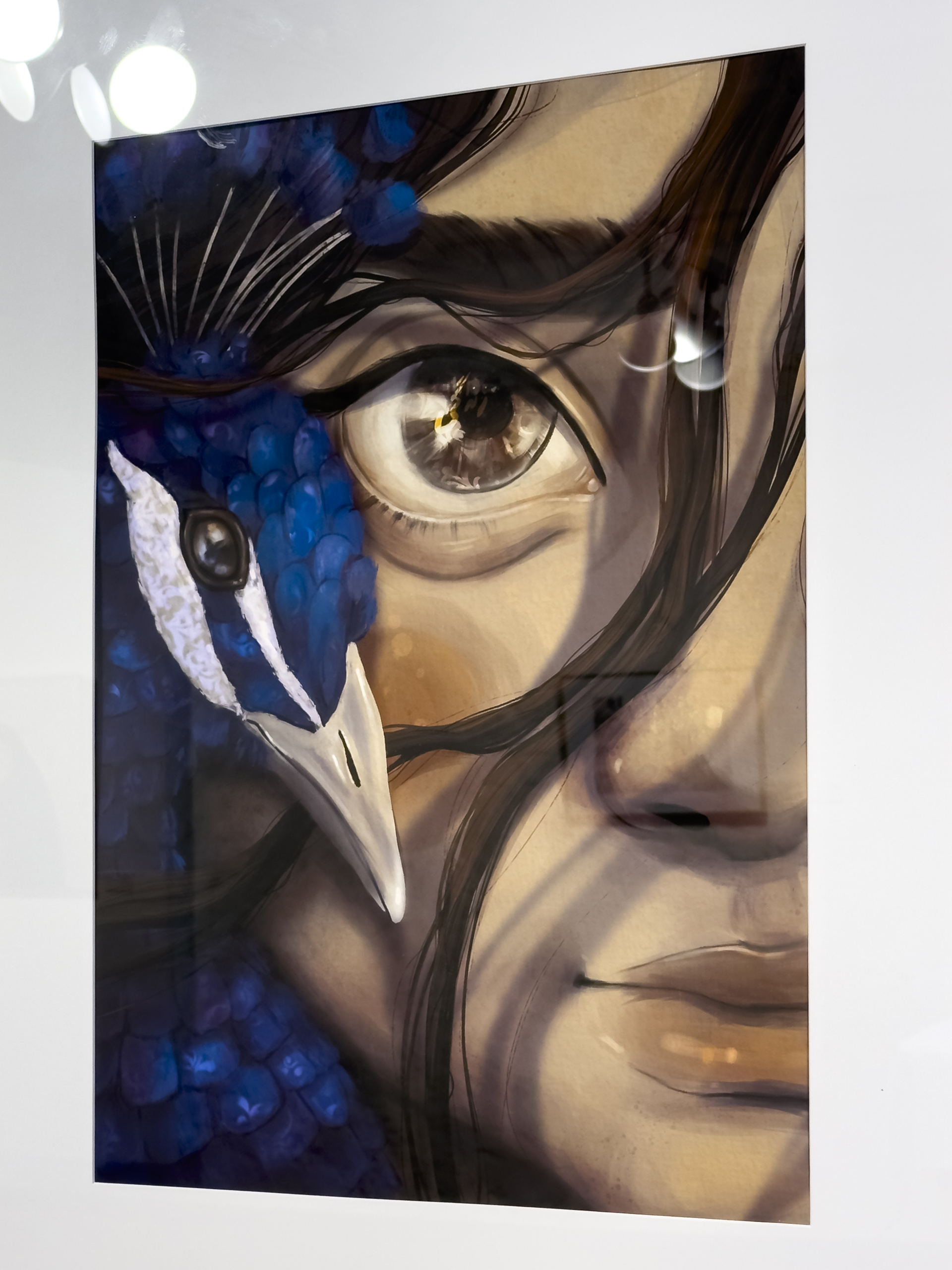 A digital painting featuing a close up of the right side of a girl's face. Her eye is brown, as is her hair There is a blue peacock leaning into her