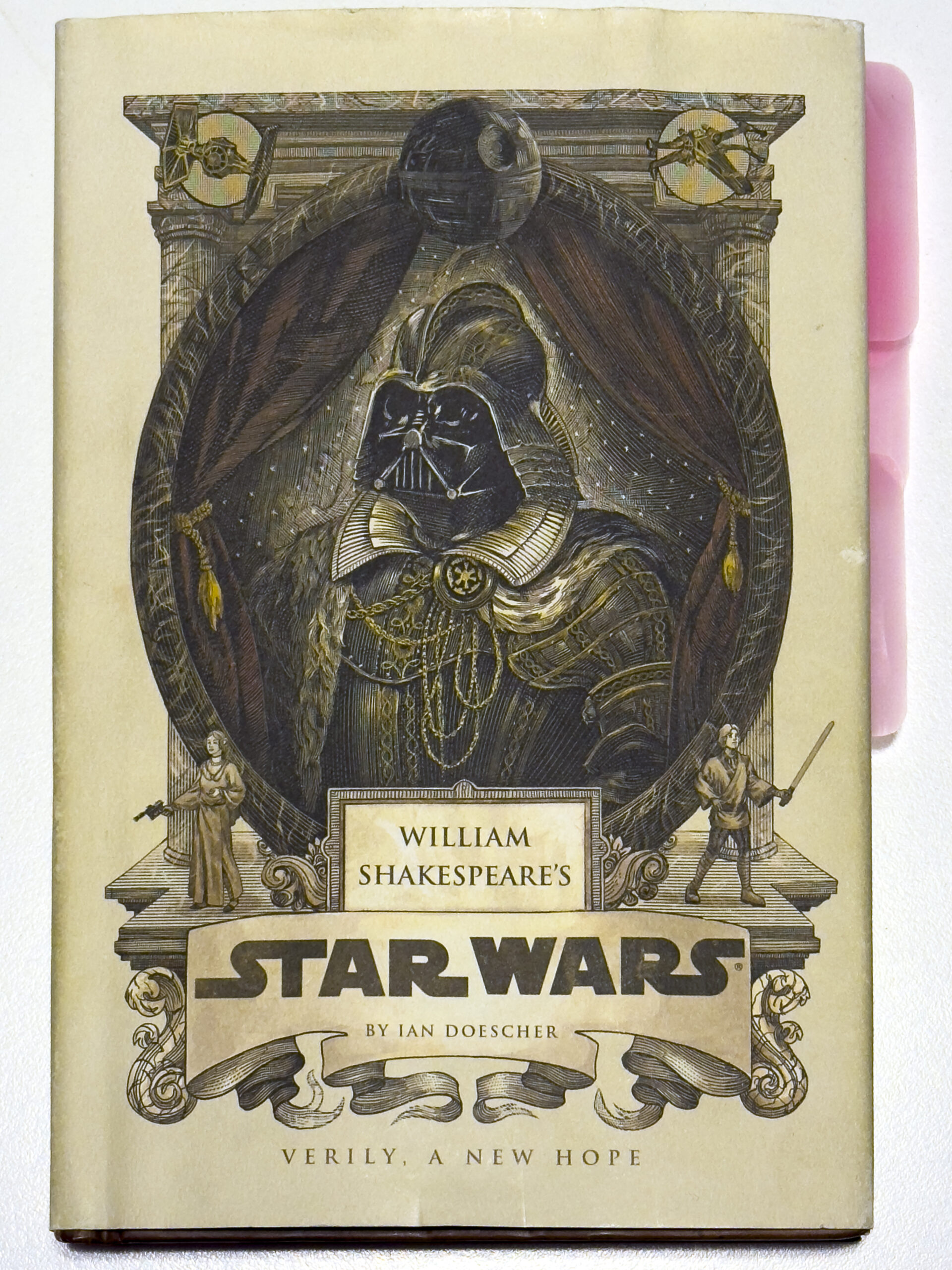 A book cover, titled Star Wars, Verily, A New Hope with an image of a hooded createre surrounded by an old-looking stage