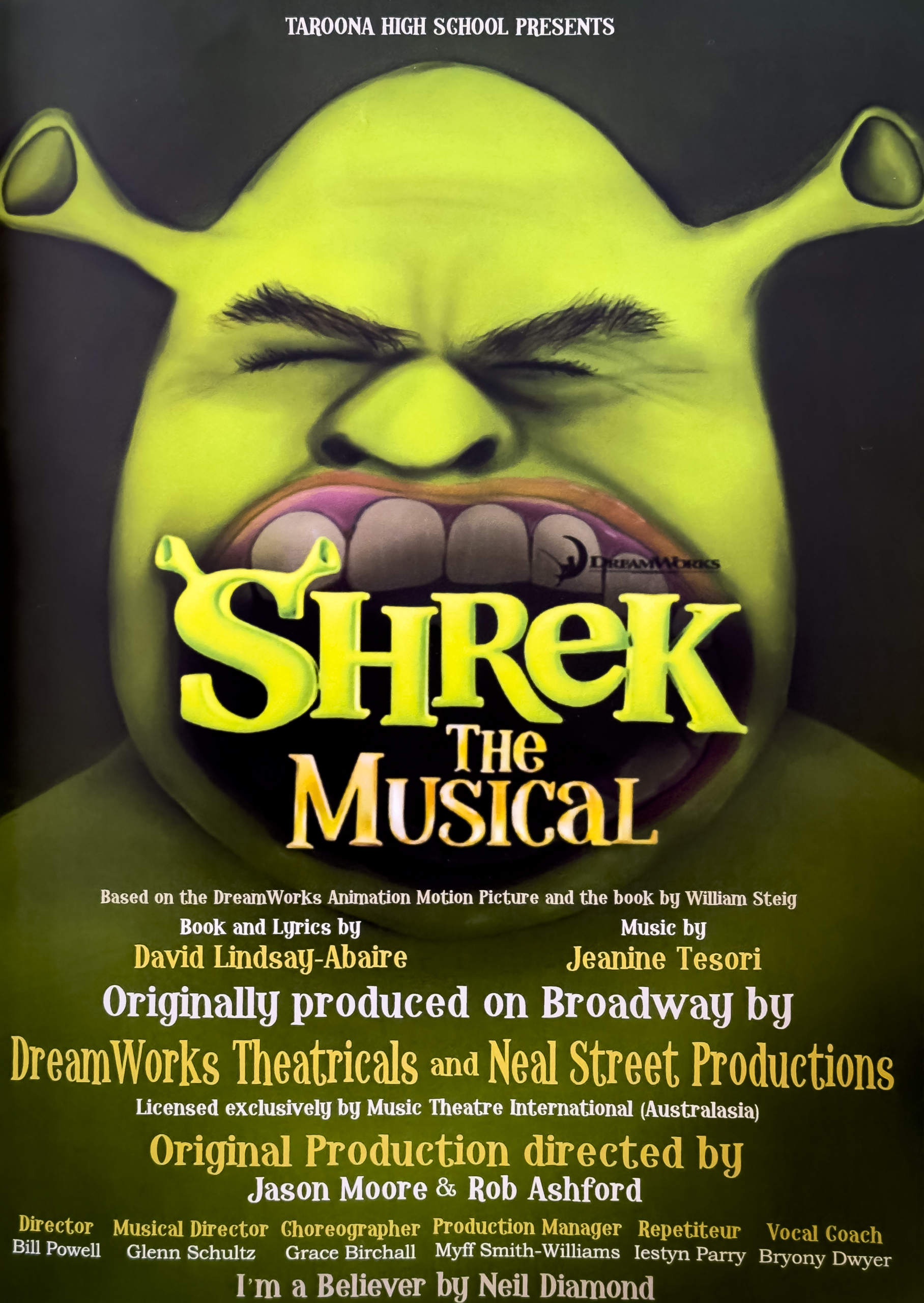 Cover of the program for Shrek The Musical. It has a large picture of Shrek, a green ogre, baring his teeth