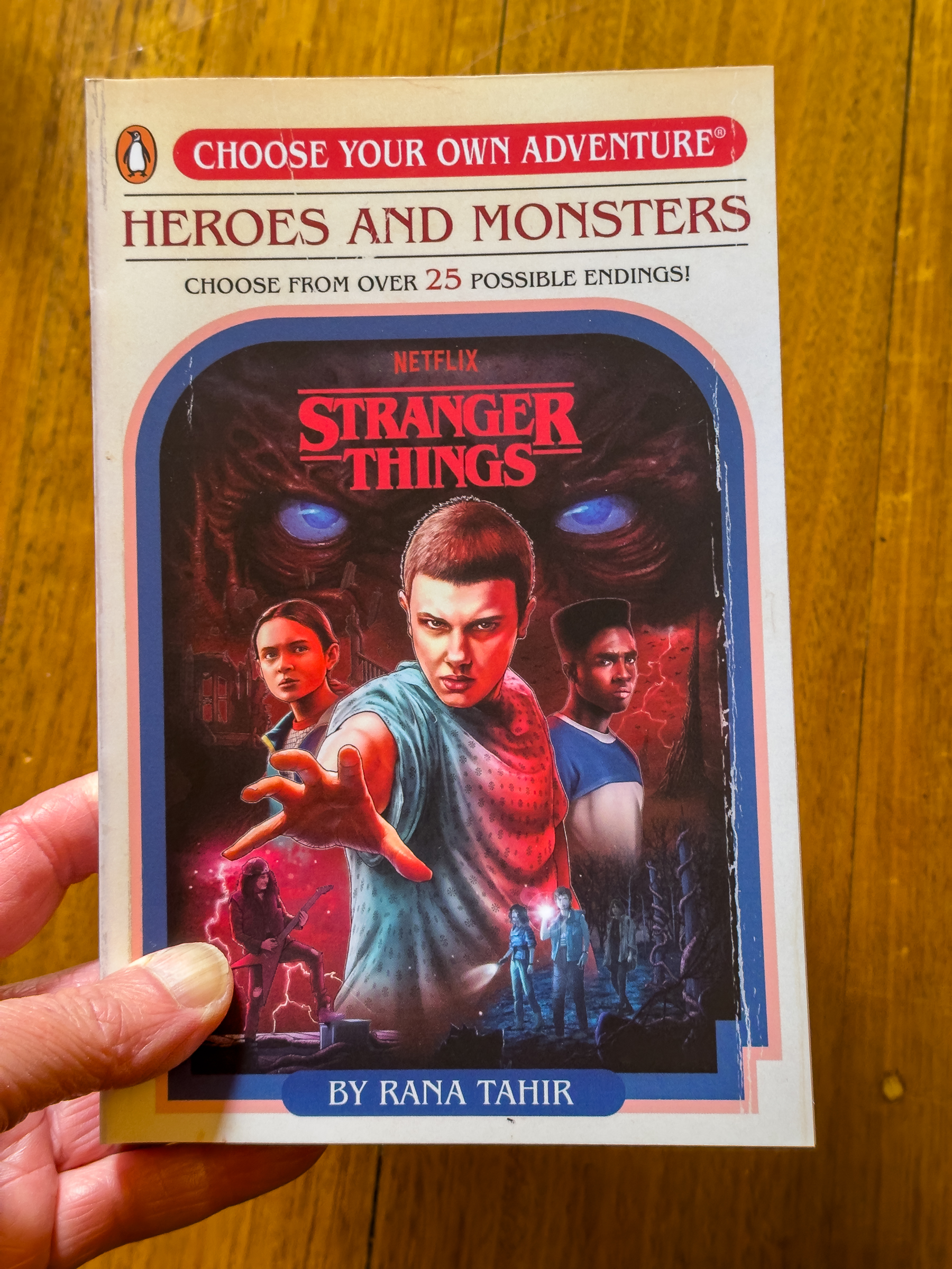 A book called Choose Your Own Adventure, Heroes and Monsters, based off the TV show Stranger Things. Three of the show's characters are pictured on the cover