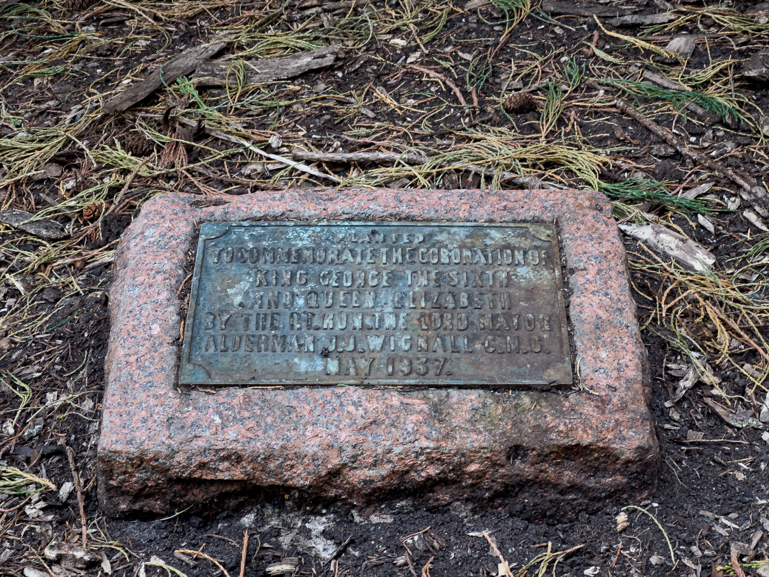 A plaque noting trees planted in 1937 to commemorate the king's coronation