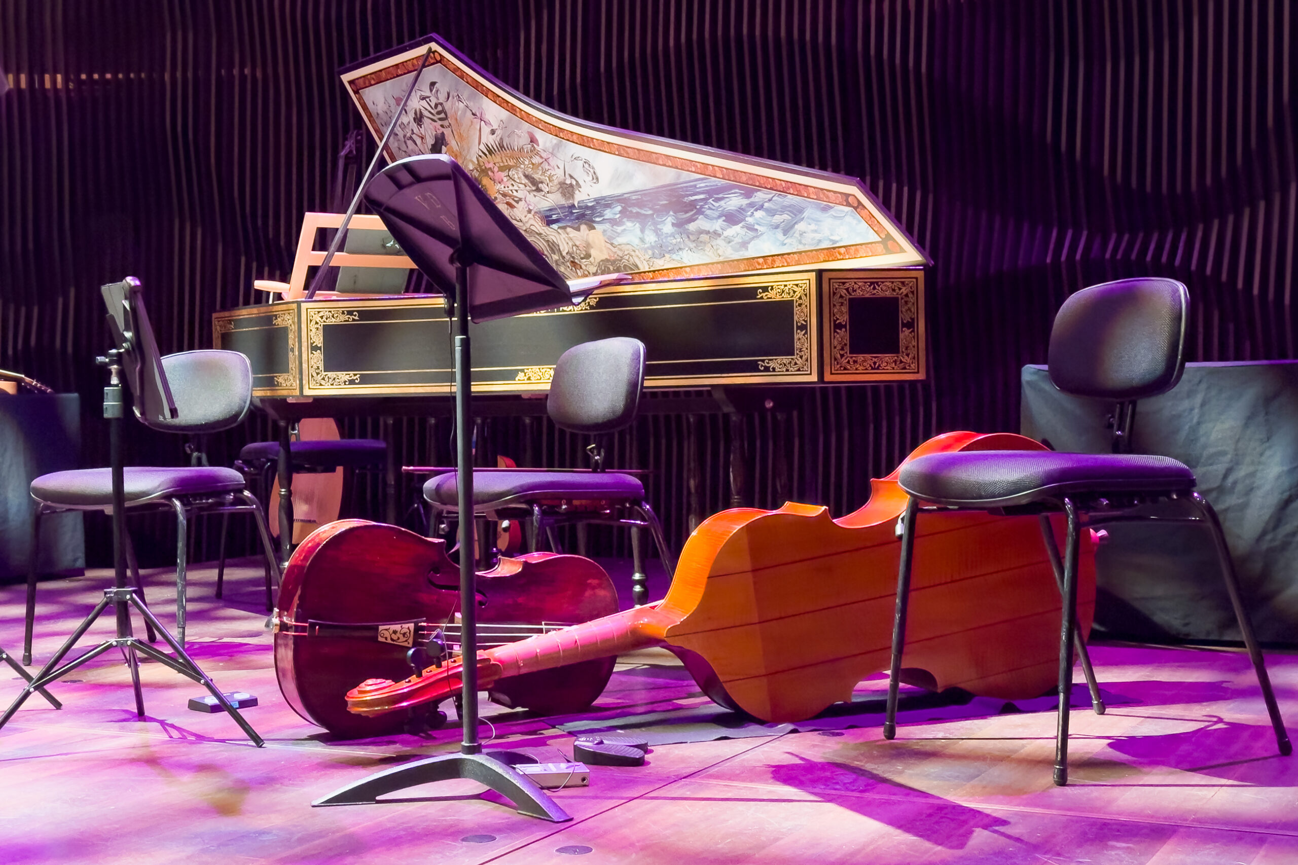 some baroque stringed instruments on a stage setting