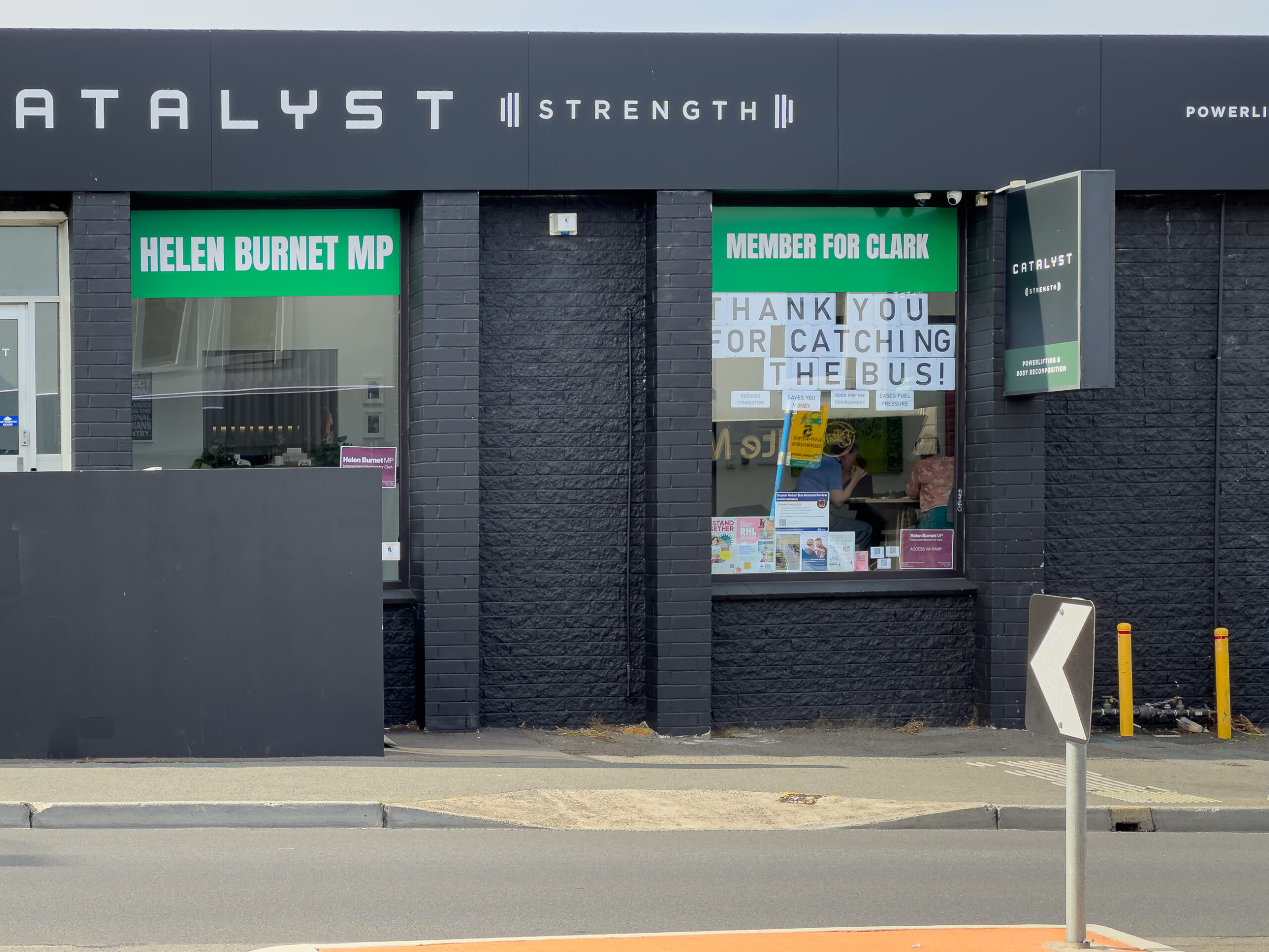 Helen Burnet MP's office facade with a sign "Thank you for catching the bus" in the window