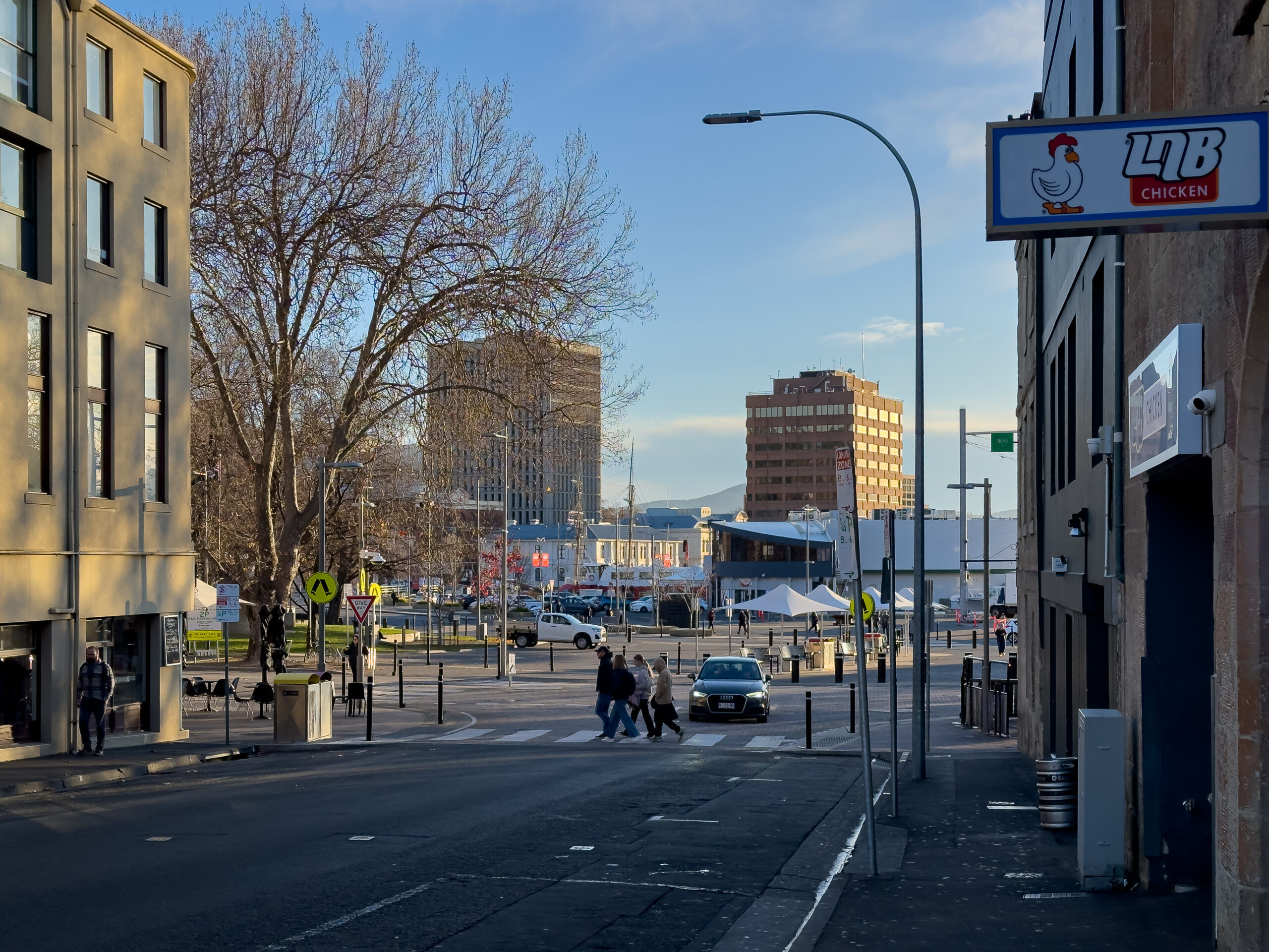 A street scene looking towards the waterfront where there are two tall buildings