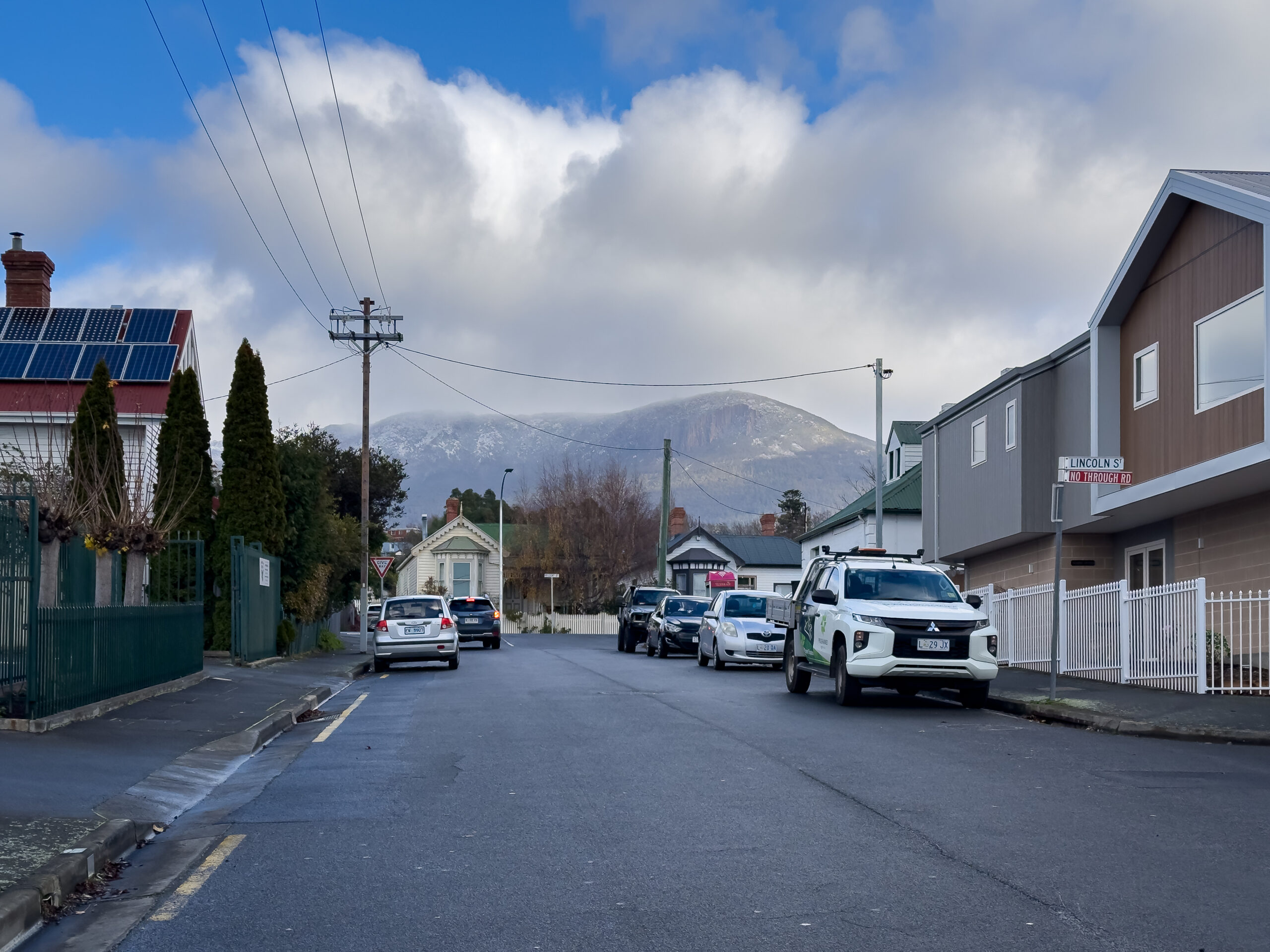 a street scene, looking towards a snow-topped mountain