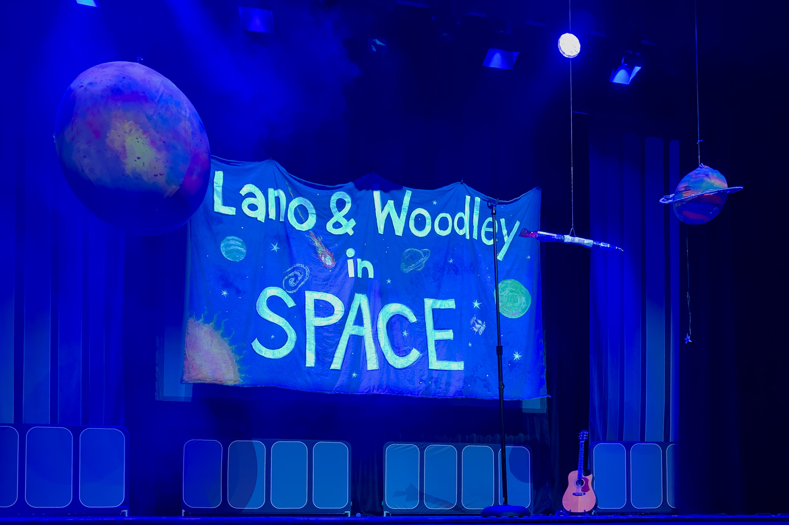 A stage set for the show Lano & Woodley In Space. It is blue and looks like outer space. 