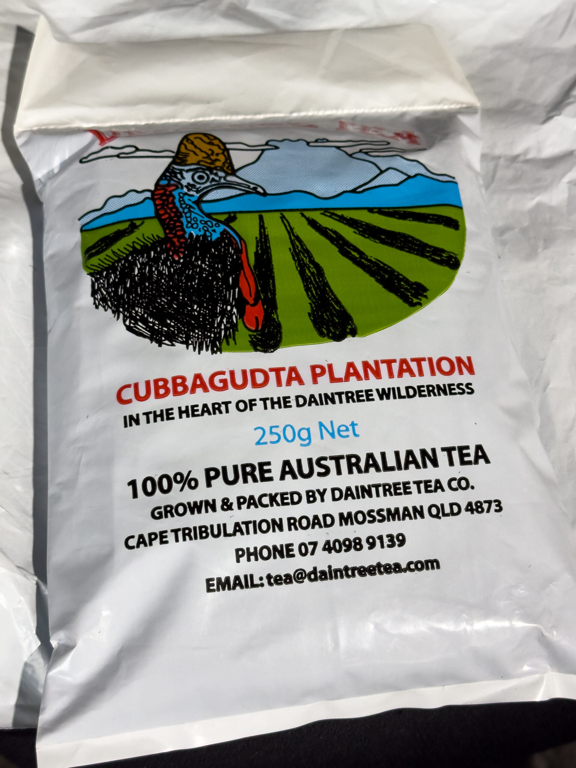 A bag of tea from the Daintree. There is a picture of a cassowary on the bag, along side rows of tea