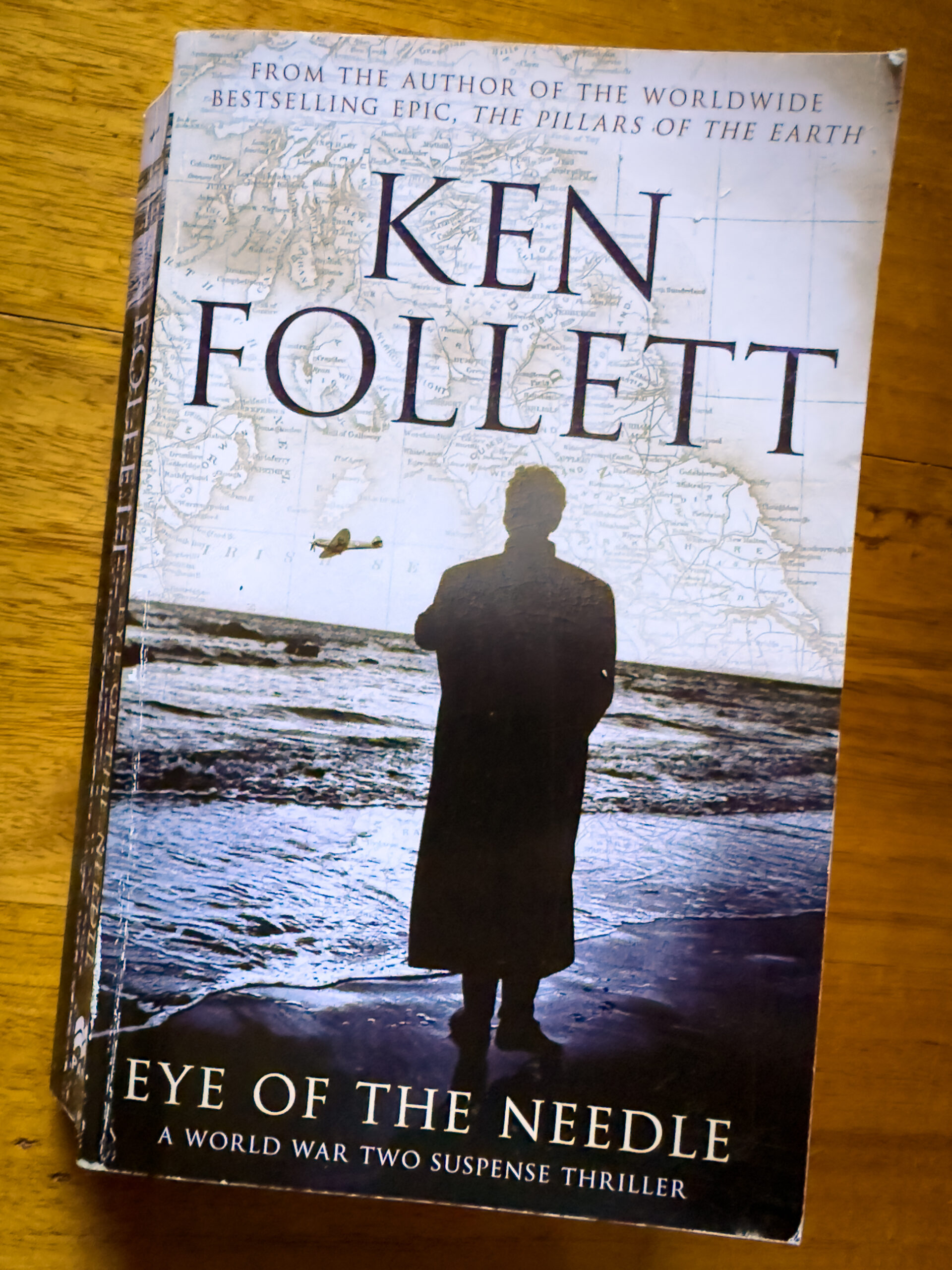 The cover of a book called Eye of the Needle yb Ken Follett. A man is standing on a beach